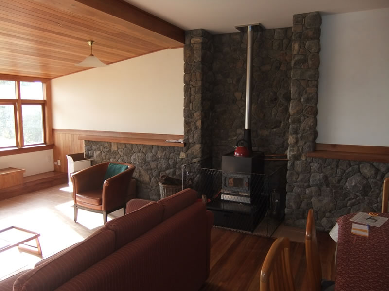 Internal thermal mass site rock wall and wood burner