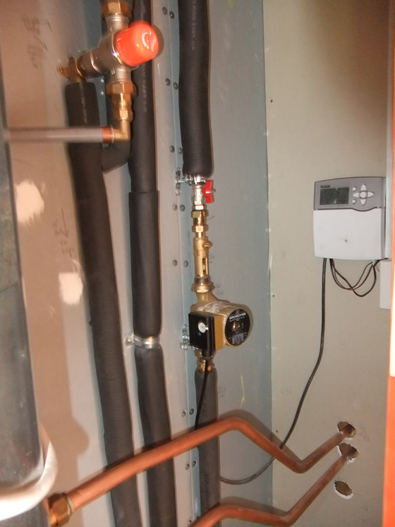 Hot water cylinder, wetback pipes, solar pipes and control panel